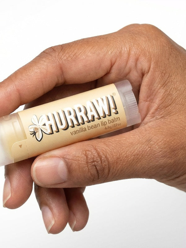 Hand holding Hurraw! Organic Lip Balm - Vanilla Bean 4.8g
