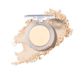 The 100% Pure Fruit Pigmented® Eye Shadow 2g by 100% Pure, with its lid open, rests on a white background as loose powder spreads around it in a graceful sweep.