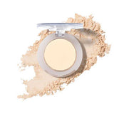 The 100% Pure Fruit Pigmented® Eye Shadow 2g by 100% Pure, with its lid open, rests on a white background as loose powder spreads around it in a graceful sweep.