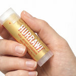 Hand holding Hurraw! Vata Lip Balm Almond Cardamom & Rose 4.8g