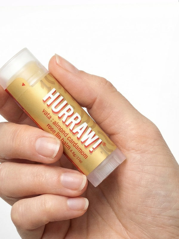 Hand holding Hurraw! Vata Lip Balm Almond Cardamom & Rose 4.8g