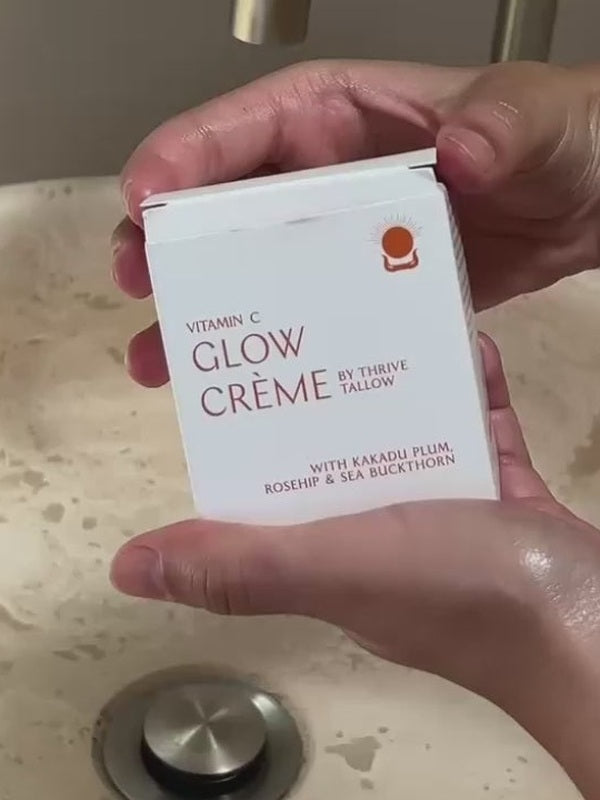 Hands holding Vitamin C Glow Creme packaging – Thrive Tallow Vitamin C Glow Creme 100ml