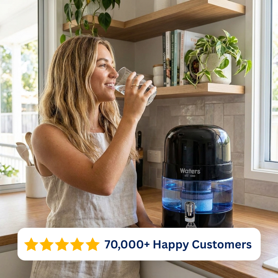 Woman drinking water beside the black Waters Co BIO 1000 benchtop water filter
