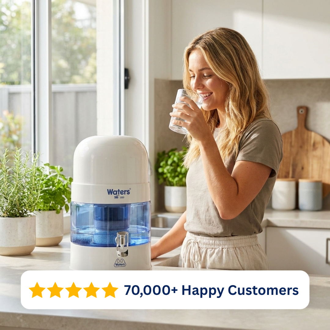Woman drinking water beside the grey Waters Co BIO 1000 benchtop water filter