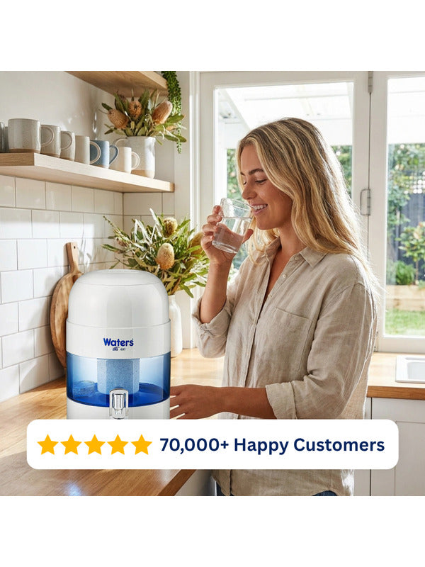 Woman drinking water beside the grey Waters Co BIO 400 benchtop water filter