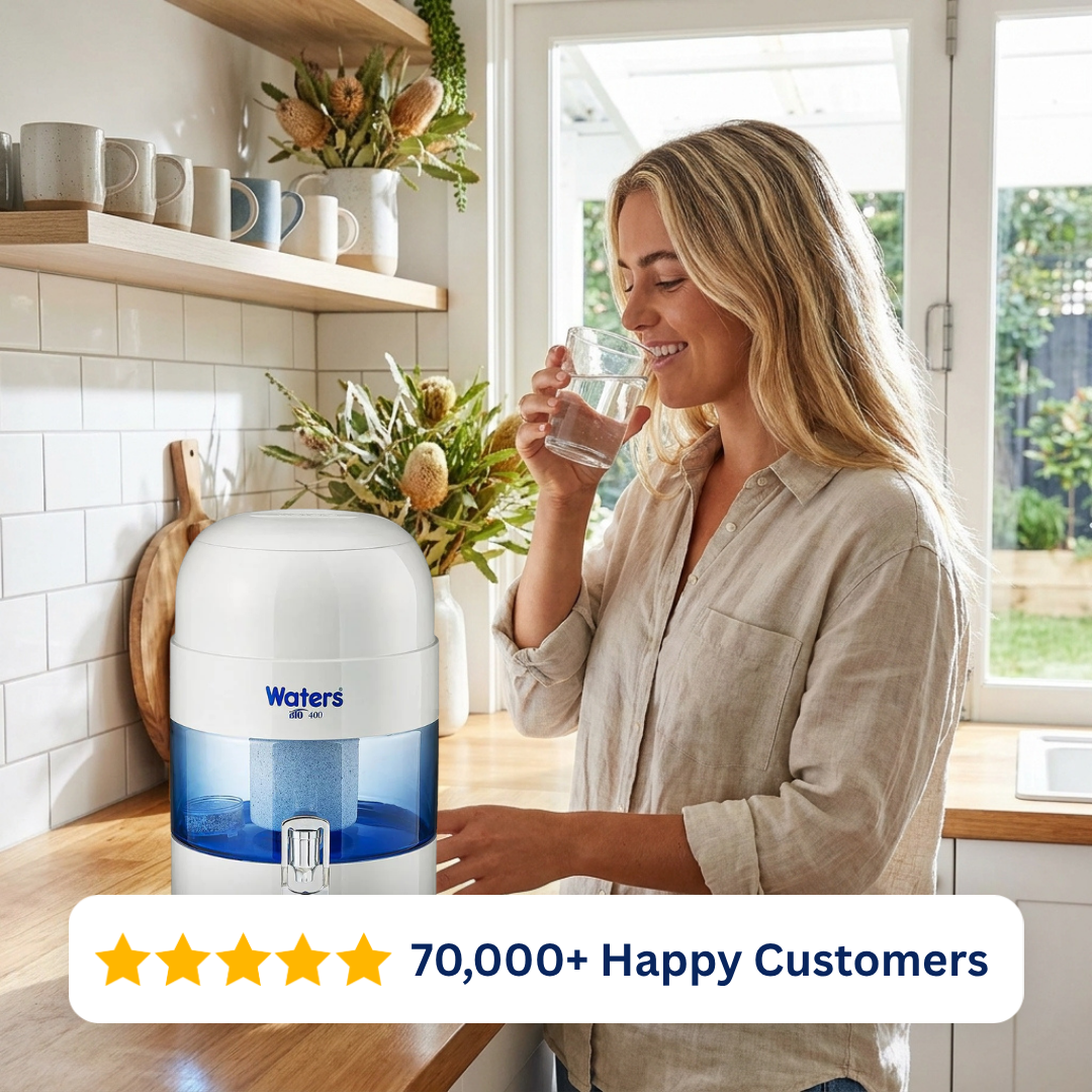 Woman drinking water beside the grey Waters Co BIO 400 benchtop water filter