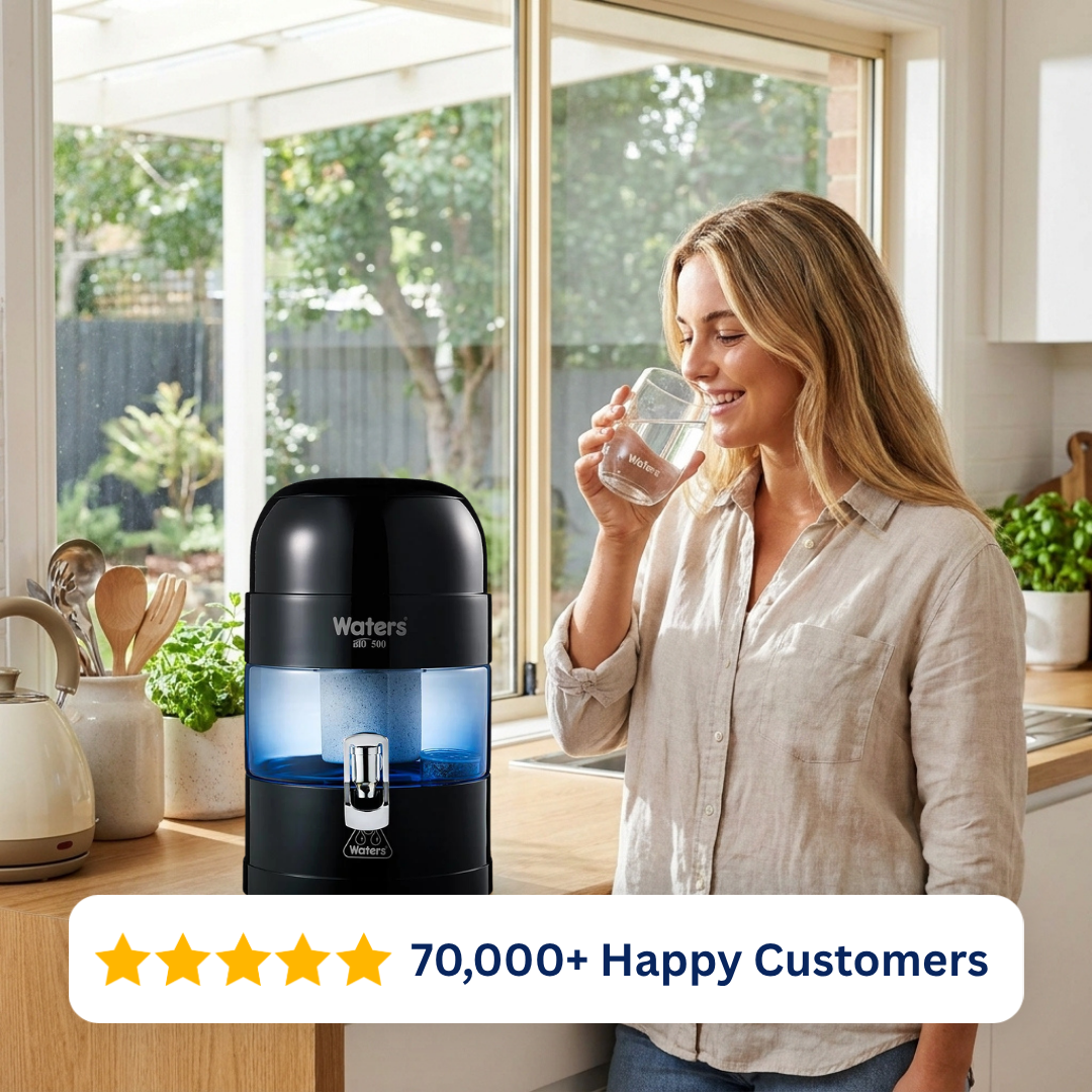 Woman drinking water beside the black Waters Co BIO 500 benchtop water filter