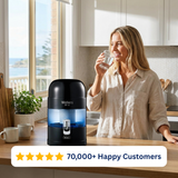 Woman drinking water beside the black Waters Co BIO 500 MAX benchtop water filter