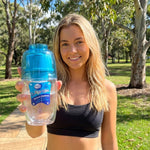Woman holding the blue Waters Co Waterman portable filter outdoors