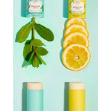 Deodorant Stick Citrus-Bergamot and Eucalyptus-Peppermint opened with peppermint leaves and slices of lemon.