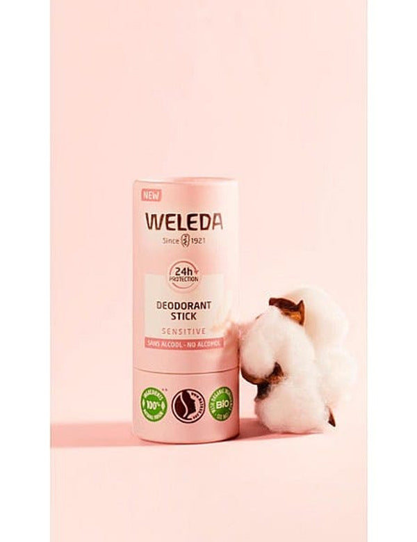 Deodorant Stick Sensitive, next to almond blossom, against pink background.