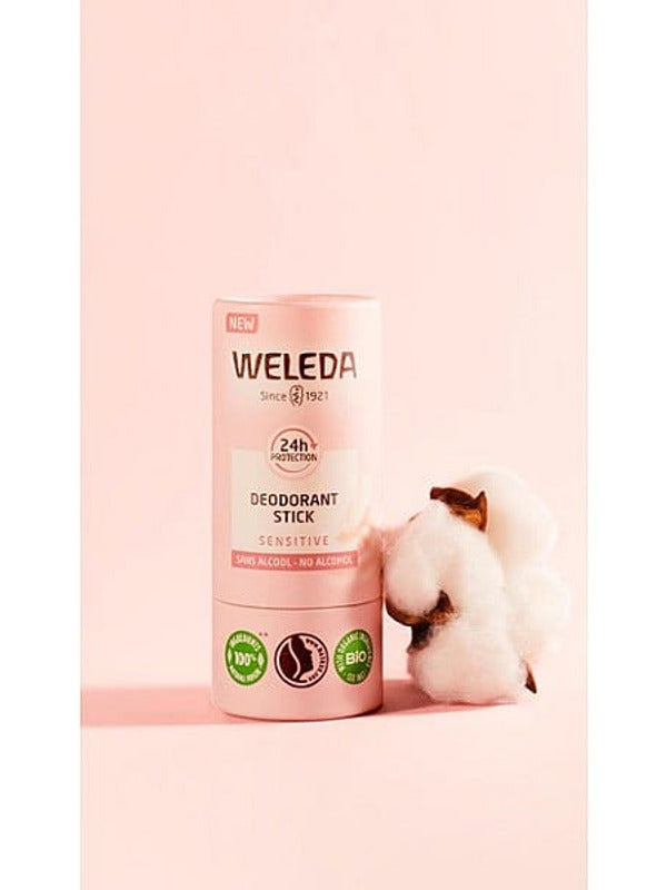 Deodorant Stick Sensitive, next to almond blossom, against pink background.