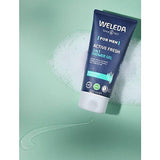 Tube of Weleda Men Active Fresh3-in-1 Shower Gel with eucalyptus and vetiver, surrounded by foam and gel on a light green background.