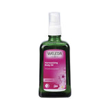 Weleda Harmonising Body Oil Wild Rose in a green bottle with a delicate Damask Rose scent for all skin types.