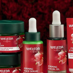 Weleda Pomegranate Firming face care range arranged against deep red florals, including night cream, day cream, serum, facial oil and eye cream.