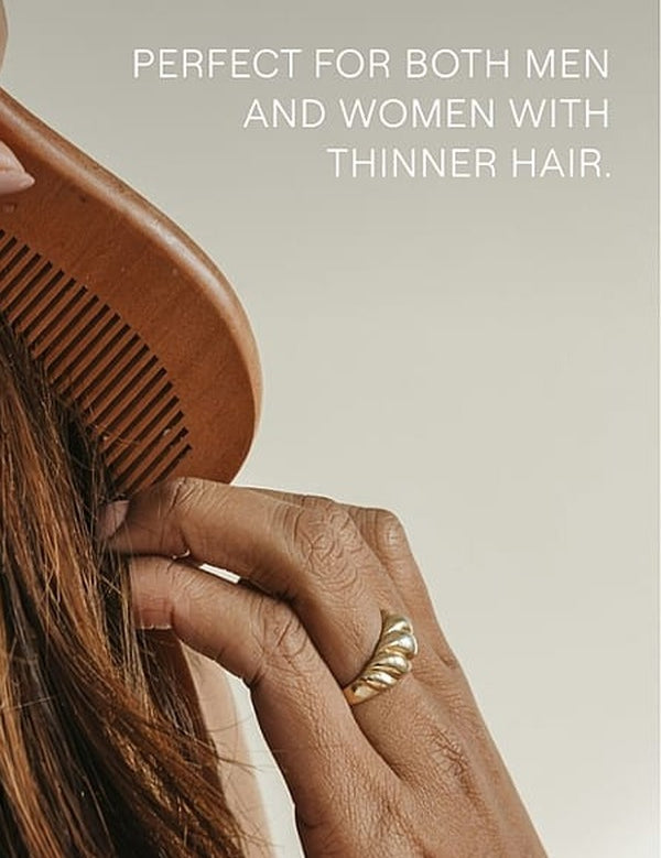 Hands drawing a wooden comb through long brown hair beneath text noting suitability for men and women with thinner hair.
