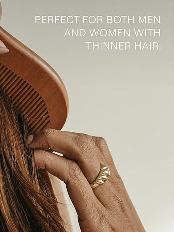 Hands drawing a wooden comb through long brown hair beneath text noting suitability for men and women with thinner hair.