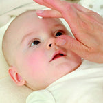 Baby with Weleda White Mallow cream being gently applied