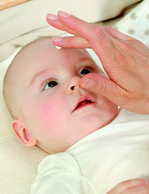 Baby with Weleda White Mallow cream being gently applied