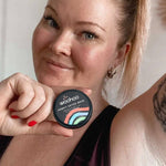 Woman holding WooHoo Armpit Detox Mask beside her underarm