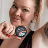 Woman holding WooHoo Armpit Detox Mask beside her underarm