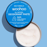 Open WooHoo Drift deodorant paste showing its creamy texture on a blue background