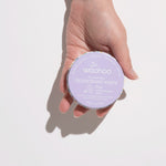 WooHoo Pop natural deodorant paste held in a hand