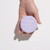 WooHoo Pop natural deodorant paste held in a hand