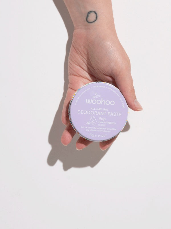 WooHoo Pop natural deodorant paste held in a hand