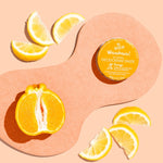 WooHoo Tango deodorant paste styled with fresh citrus on a peach background
