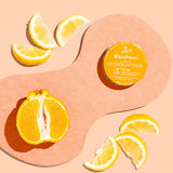 WooHoo Tango deodorant paste styled with fresh citrus on a peach background