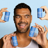 Smiling man surrounded by WooHoo Drift natural deodorant sticks