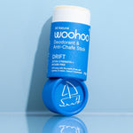 WooHoo Drift deodorant stick styled open on a reflective blue surface