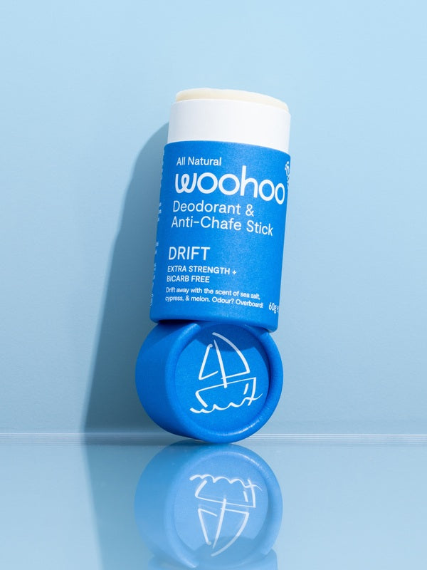 WooHoo Drift deodorant stick styled open on a reflective blue surface
