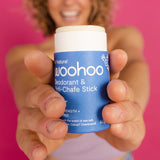 Woman holding WooHoo Drift deodorant stick toward the camera