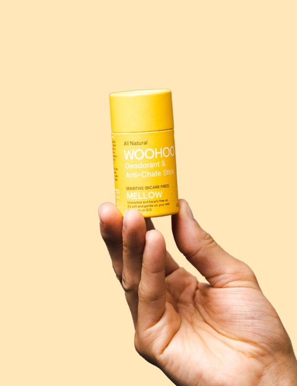 WooHoo Mellow sensitive deodorant stick held in a hand