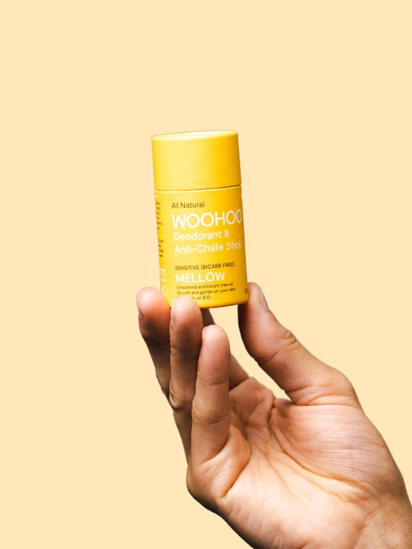 WooHoo Mellow sensitive deodorant stick held in a hand