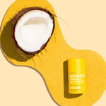 WooHoo Mellow deodorant stick styled with coconut on a yellow background