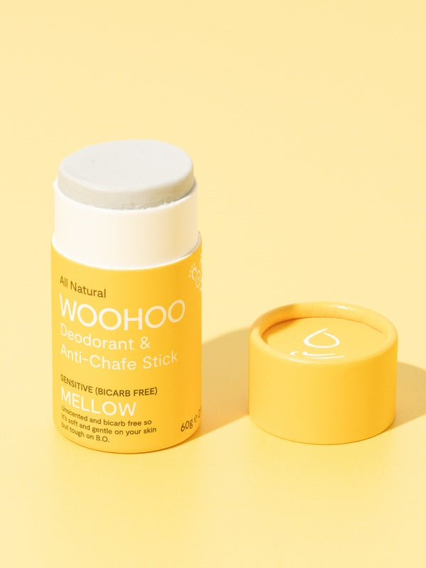 Open WooHoo Mellow deodorant stick styled on a yellow background