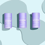 Three WooHoo Pop natural deodorant sticks styled on a graphic background