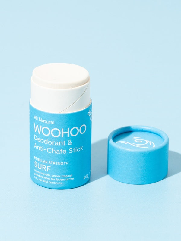 Open WooHoo Surf deodorant stick styled on a blue background