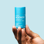 WooHoo Surf natural deodorant stick held in a hand