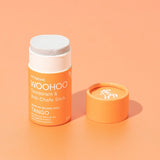 Open WooHoo Tango deodorant stick styled on a peach background