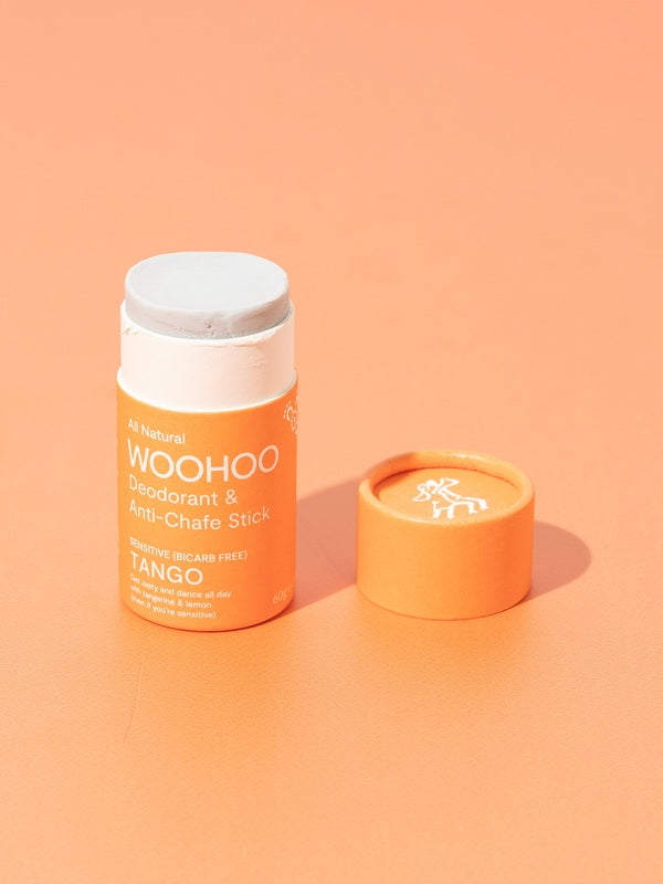 Open WooHoo Tango deodorant stick styled on a peach background