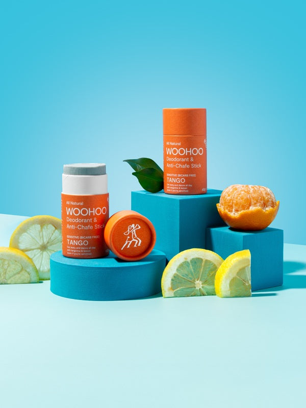 WooHoo Tango deodorant sticks styled with citrus on bright blue blocks