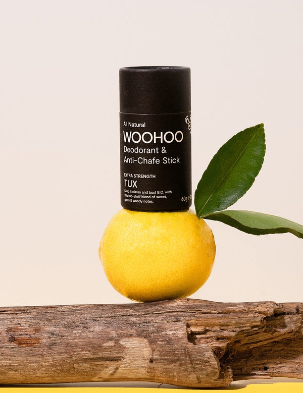 WooHoo Tux deodorant stick balanced on lemon and eucalyptus branches