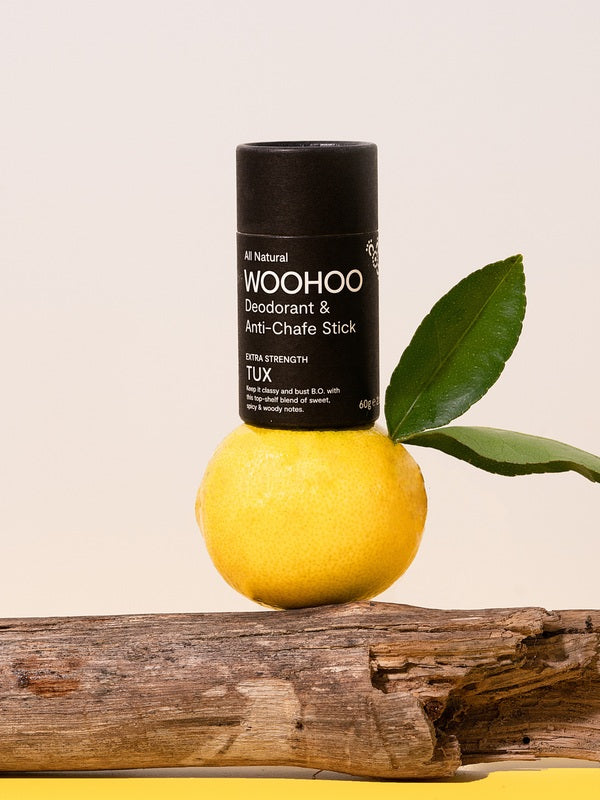 WooHoo Tux deodorant stick balanced on lemon and eucalyptus branches