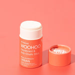 Open WooHoo Urban deodorant stick styled on a coral background