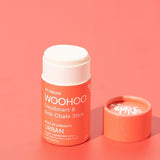 Open WooHoo Urban deodorant stick styled on a coral background