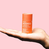 WooHoo Urban natural deodorant stick balanced on an open hand